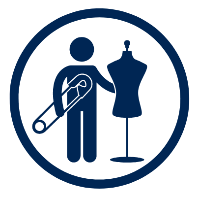 student holding safety pin standing next to fashion mannequin